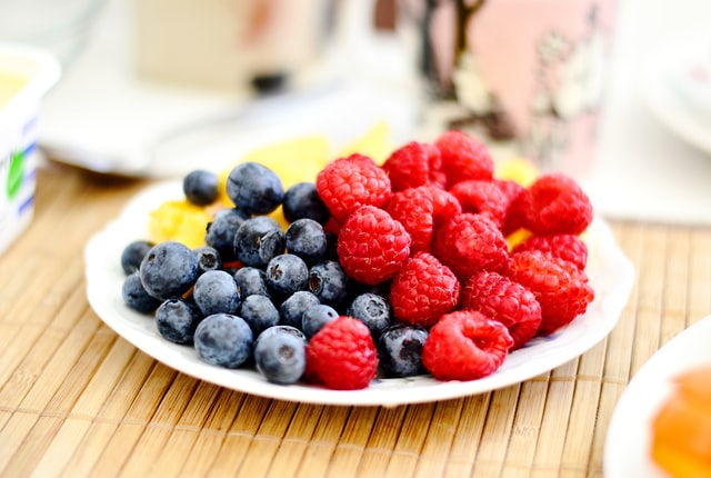 colourful plate of blueberries and raspberries